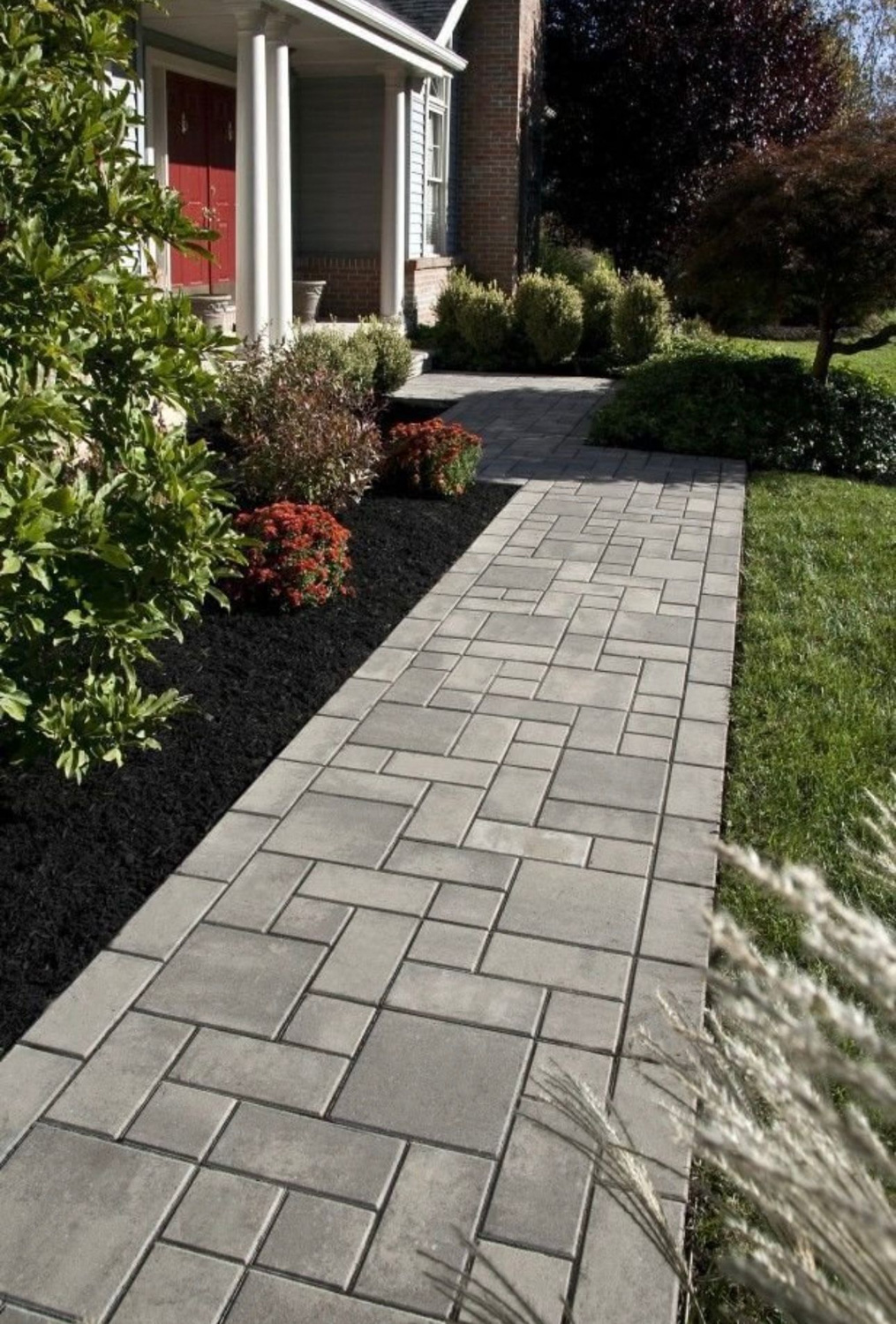 Stepping-stone style ashlar paver walkway installation with clean edge borders