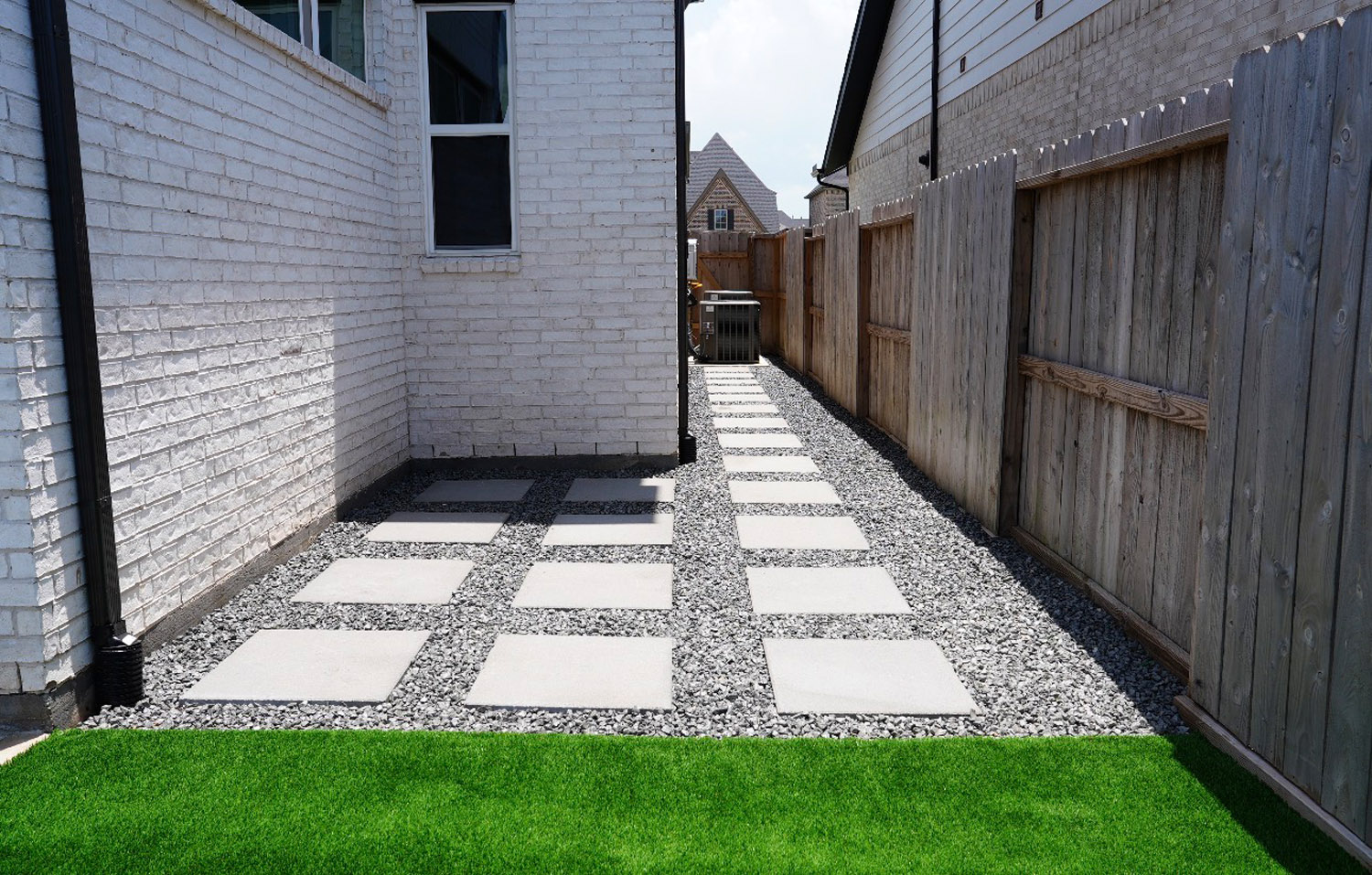 Bezuz-Landscaping-and-Design-commercial-side-pathway-square-pavers-gravel